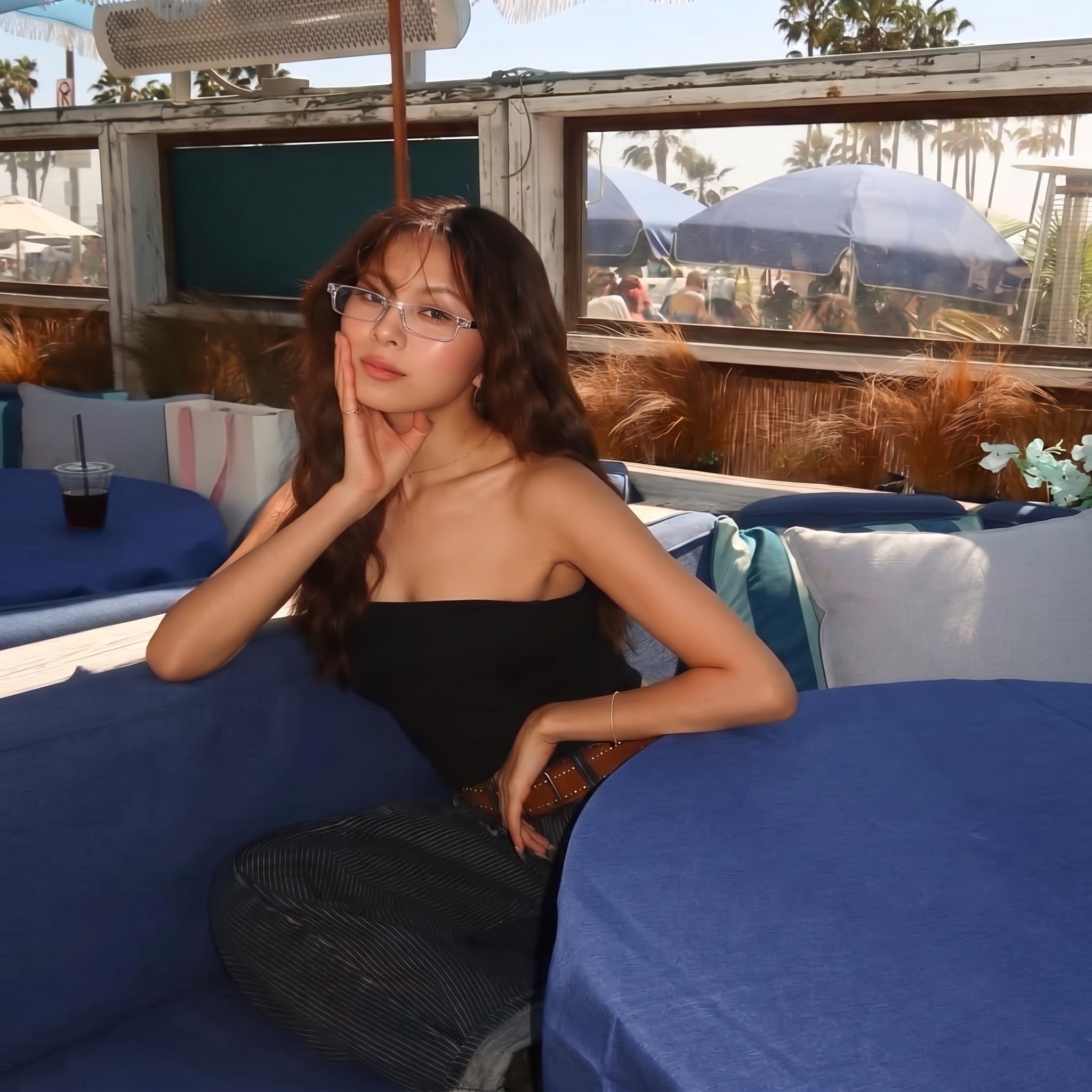 Woman wearing SKYOAK glasses at a cafe